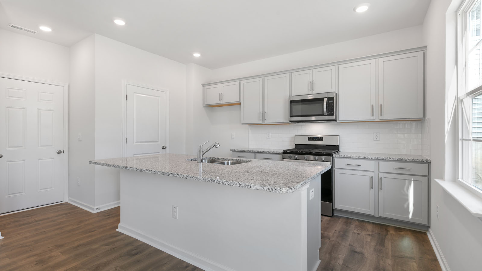 Kitchen view with gray cabinets