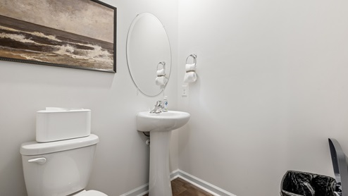 half bathroom with a pedalstool sink