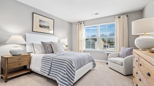 guest bedroom with double windows and carpter