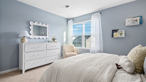 bedroom with a double window and carpet