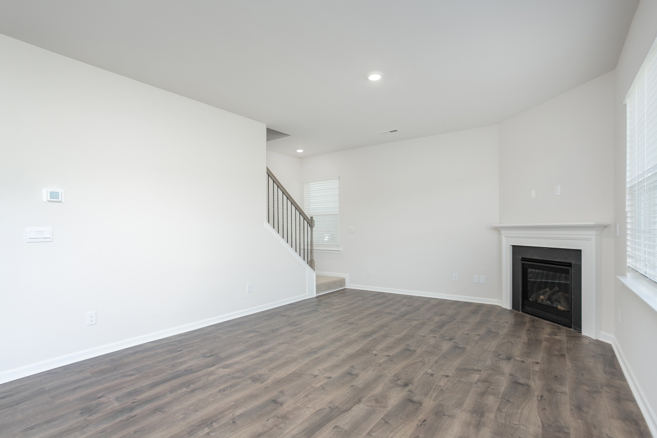 living room with revwood floors and natural light