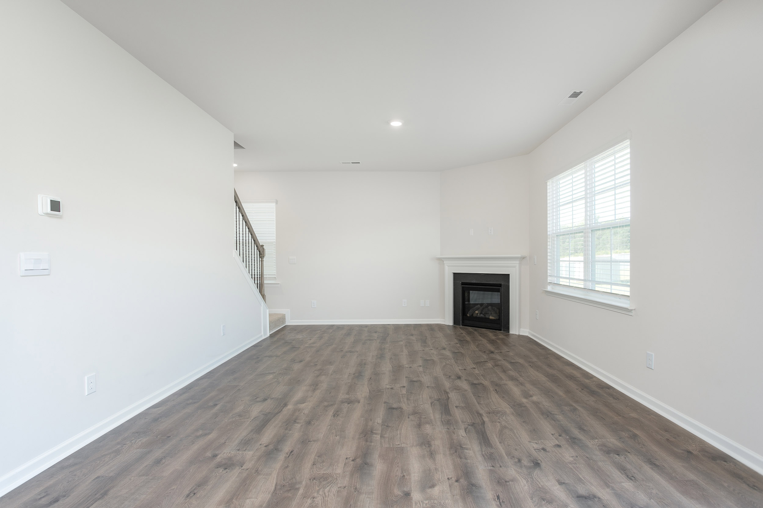 living room with revwood floors and natural light