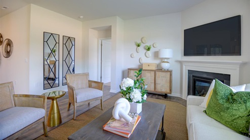 living room with revwood floors and natural light and fireplace