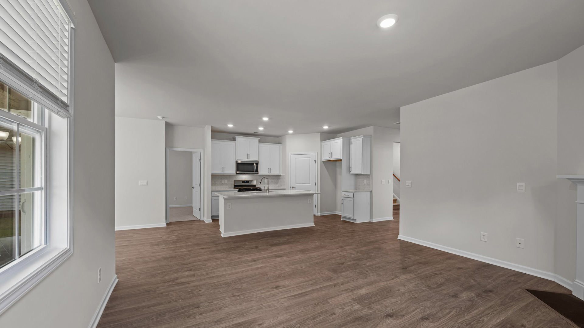 Living room to kitchen view with revewood flooring