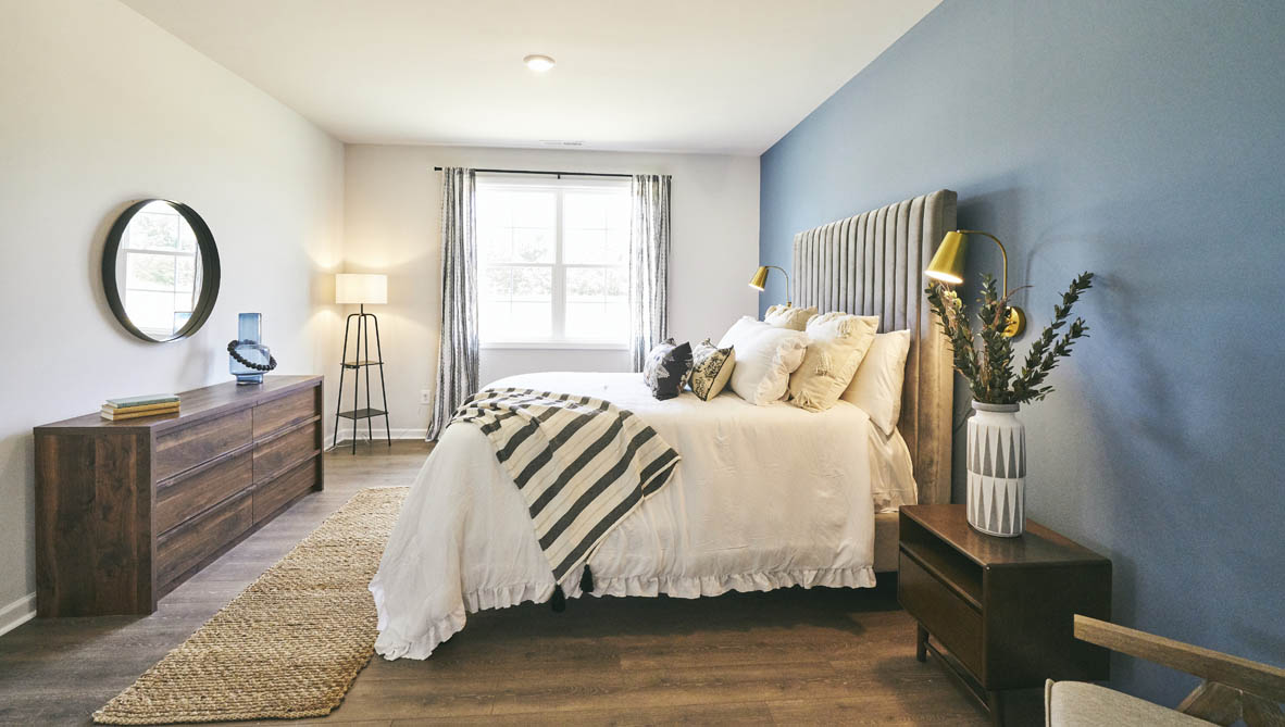 bedroom with revwood floors and natural light