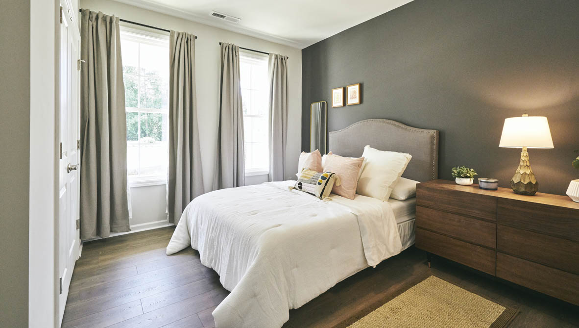 bedroom with revwood floors and natural light