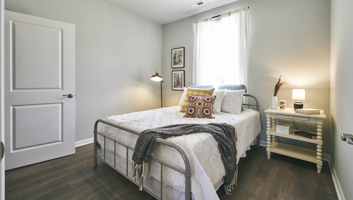 bedroom with revwood floors and natural light