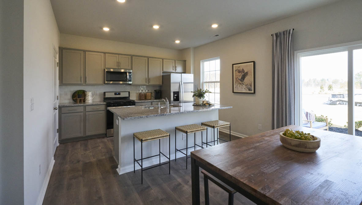 kitchen with island and revwood floors with stainless steel appliances