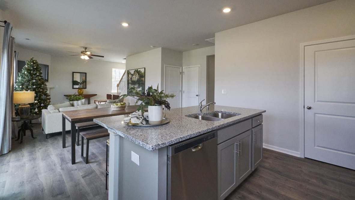 kitchen with island and revwood floors with stainless steel appliances