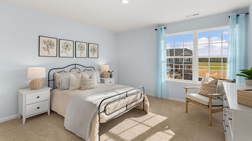 bedroom with carpet and natural light
