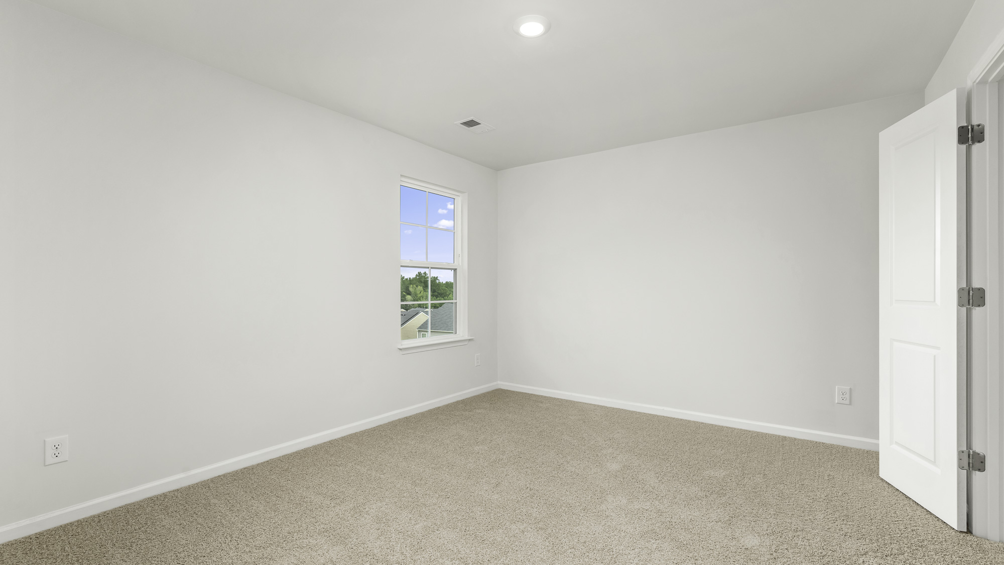 bedroom with window and carpet