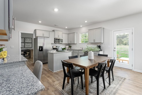 kitchen with revwood floors an island and stainless steel appliances