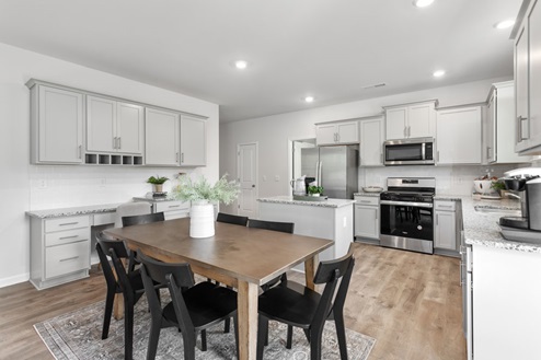 kitchen with revwood floors an island and stainless steel appliances