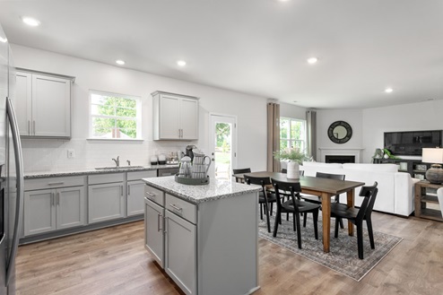 kitchen with revwood floors an island and stainless steel appliances