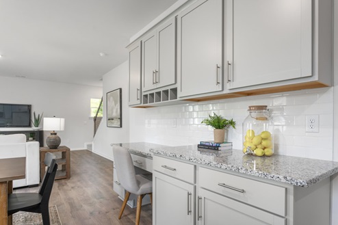 kitchen with revwood floors an island and stainless steel appliances