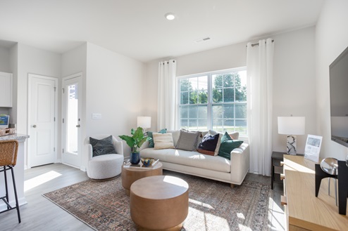living room with revwood floors and natural light