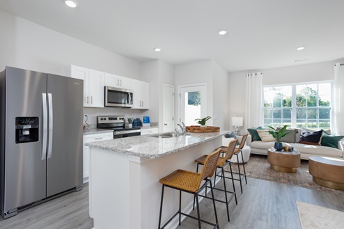 kitchen with revwood floors an island and stainless steel appliances
