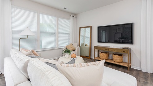 living room with revwood floors and natural light