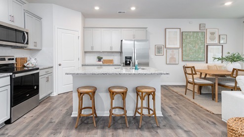 kitchen with revwood floors an island and stainless steel appliances