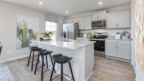 kitchen with vinyl floors an island and stainless steel appliances