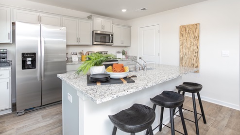 kitchen with vinyl floors an island and stainless steel appliances