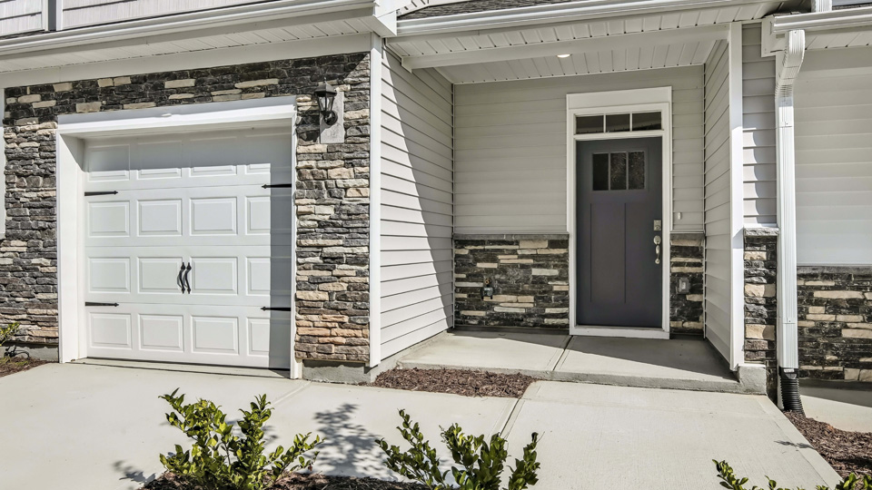 close up of Two-story townhome with an attached garage