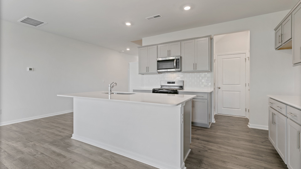 angled kitchen view with gray cabinets