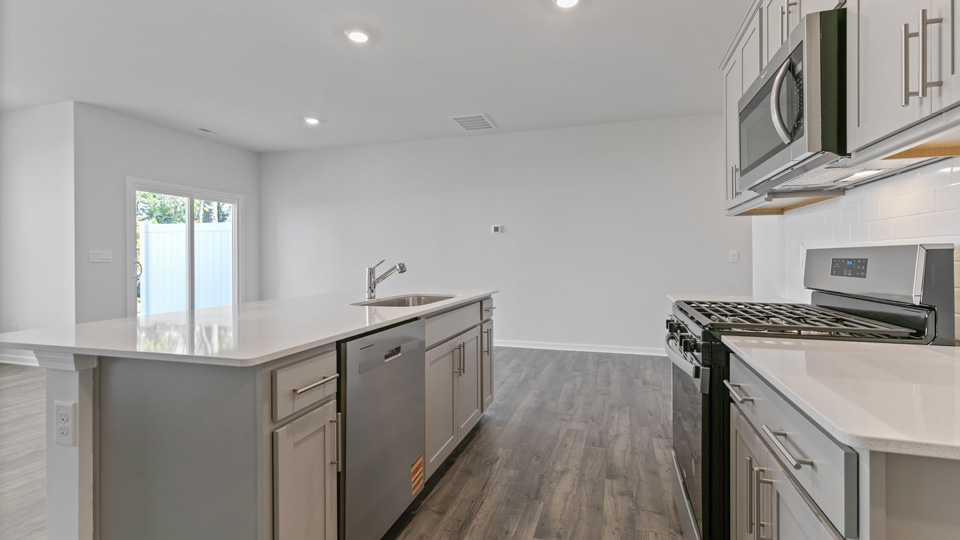 Middle kitchen view with gray cabinets