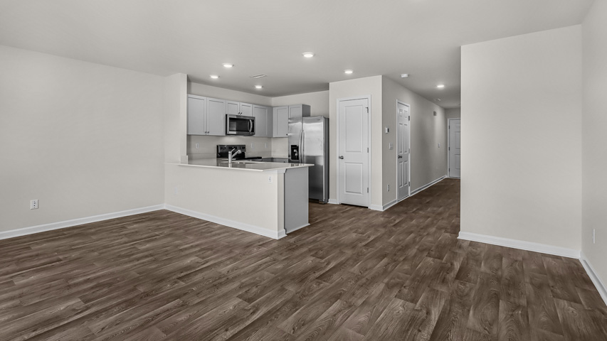 LIVING ROOM AND PARTIAL KITCHEN VIEW