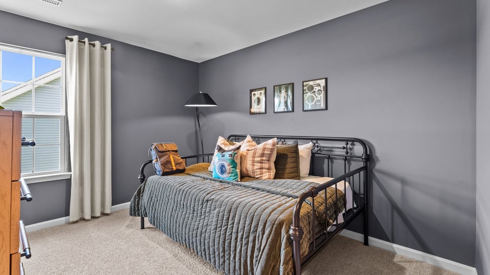 secondary bedroom with closet and carpet