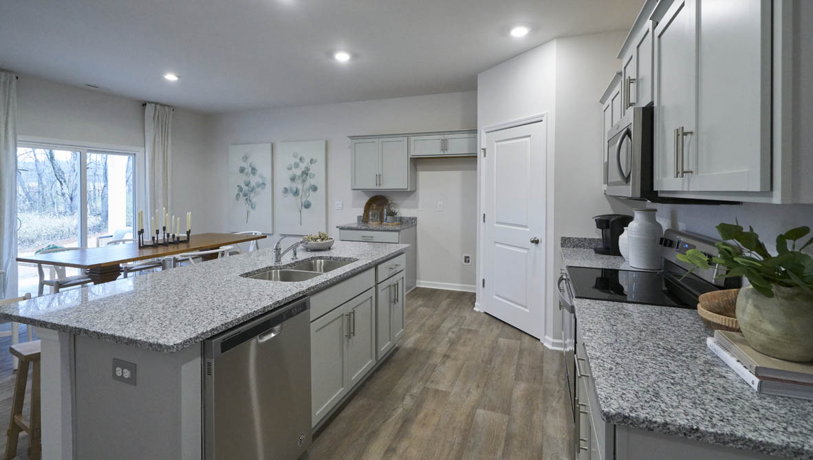kitchen with island, vinyl flooring and stainless steel appliances
