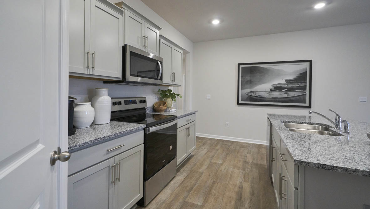 kitchen with island, vinyl flooring and stainless steel appliances