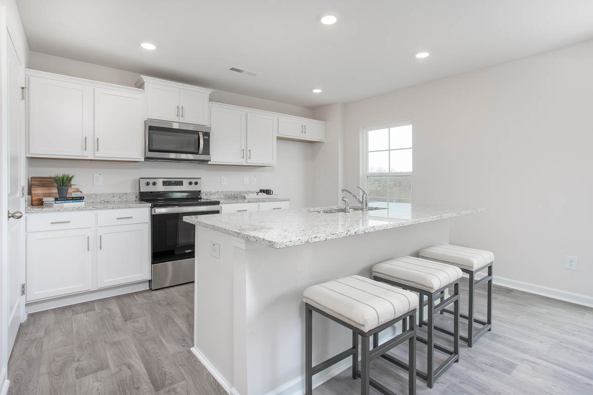 kitchen with island, vinyl floor, and stainless steel appliances
