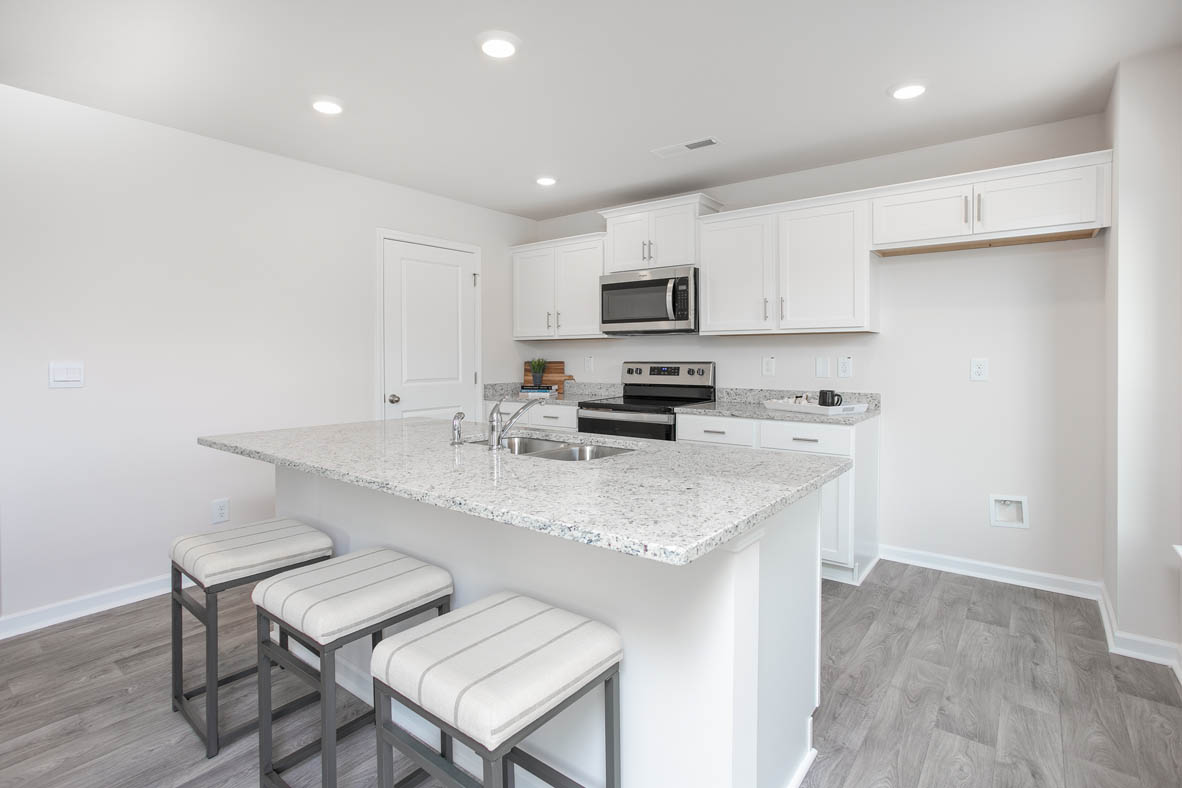 kitchen with island, vinyl floor, and stainless steel appliances