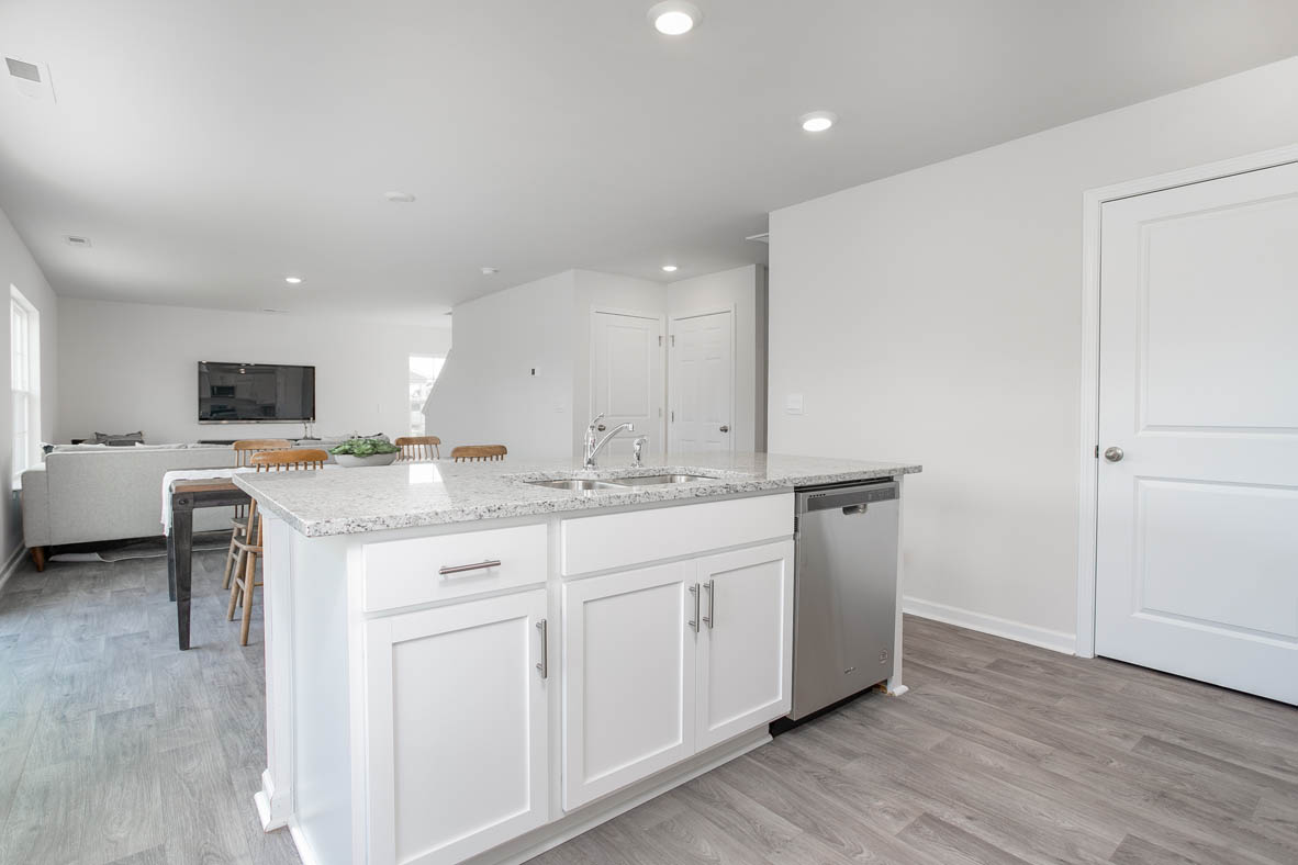 kitchen with island, vinyl floor, and stainless steel appliances