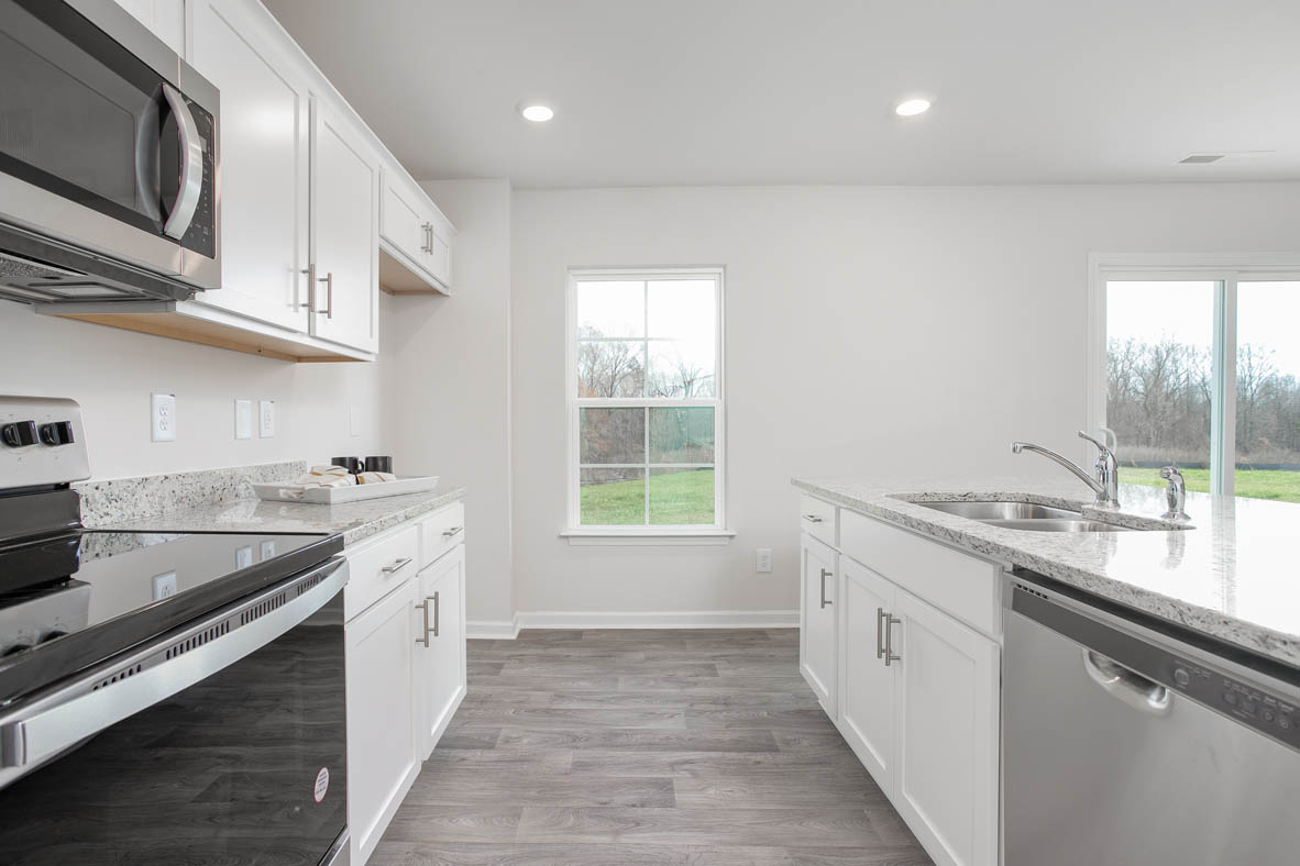 kitchen with island, vinyl floor, and stainless steel appliances