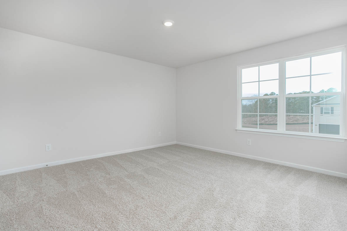 bedroom with carpet and natural light