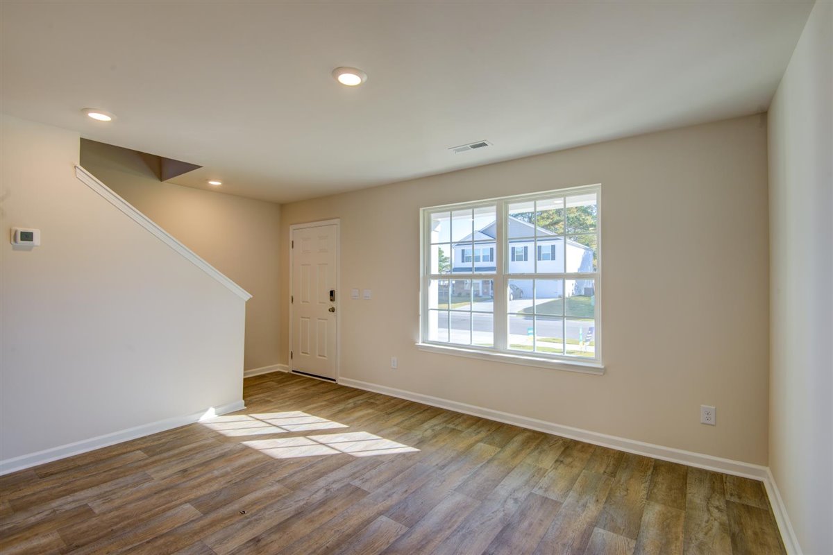 living room with vinyl floor and natural light