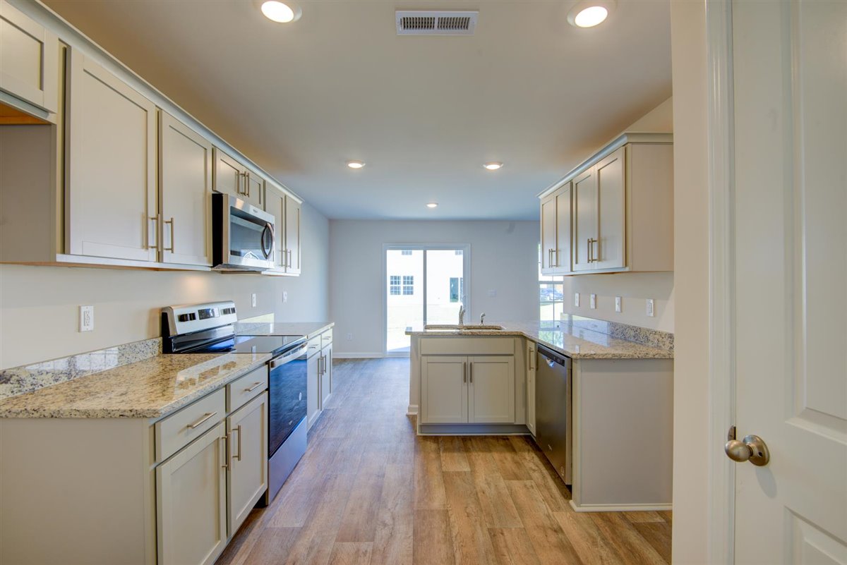 kitchen with vinyl floor and stainless steel appliances