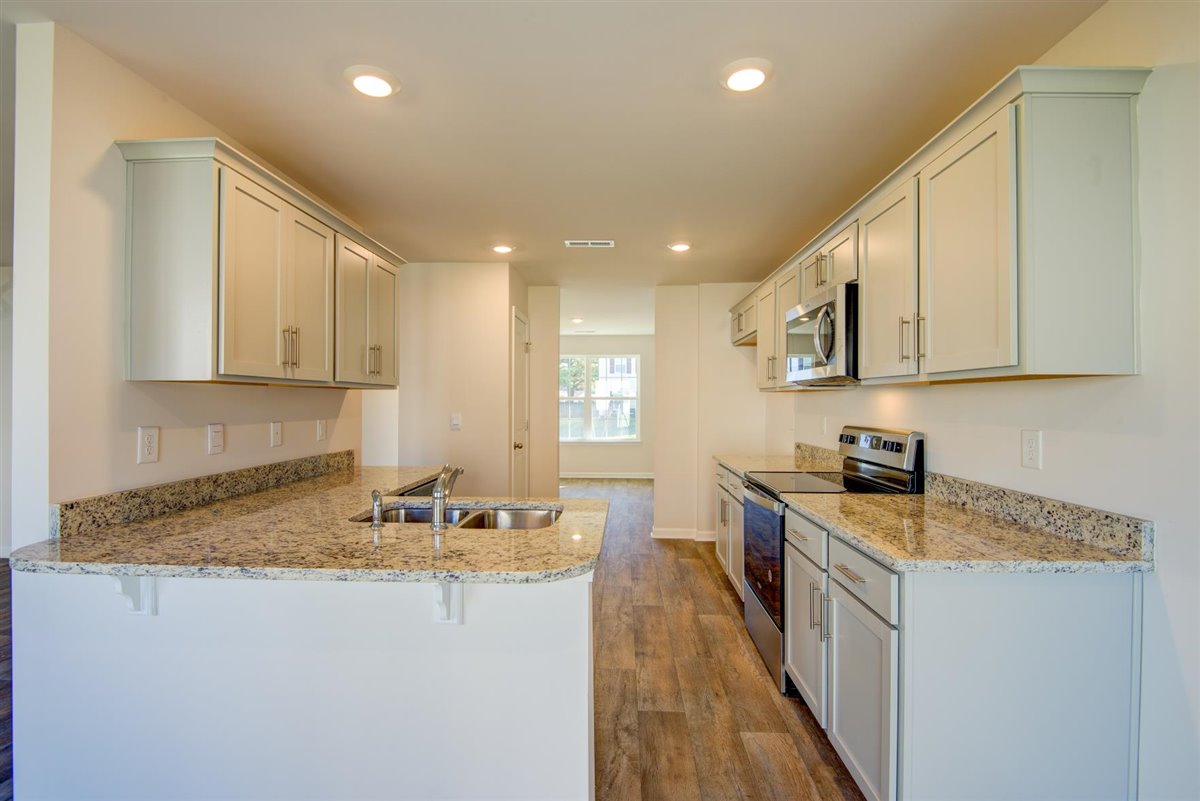 kitchen with vinyl floor and stainless steel appliances