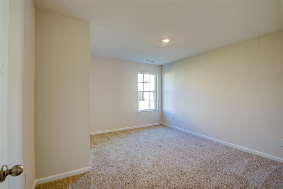 bedroom with carpet and natural light