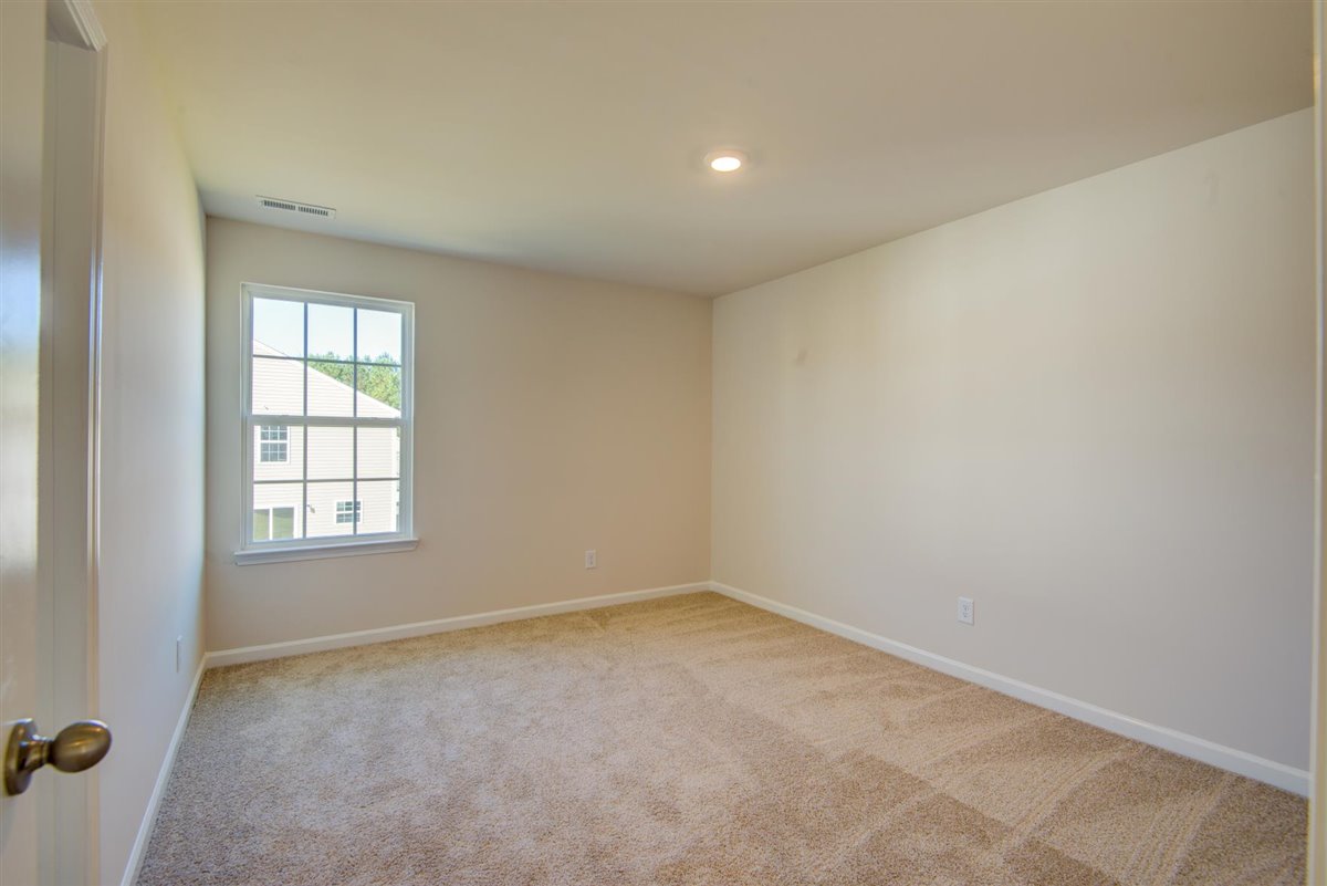 bedroom with carpet and natural light