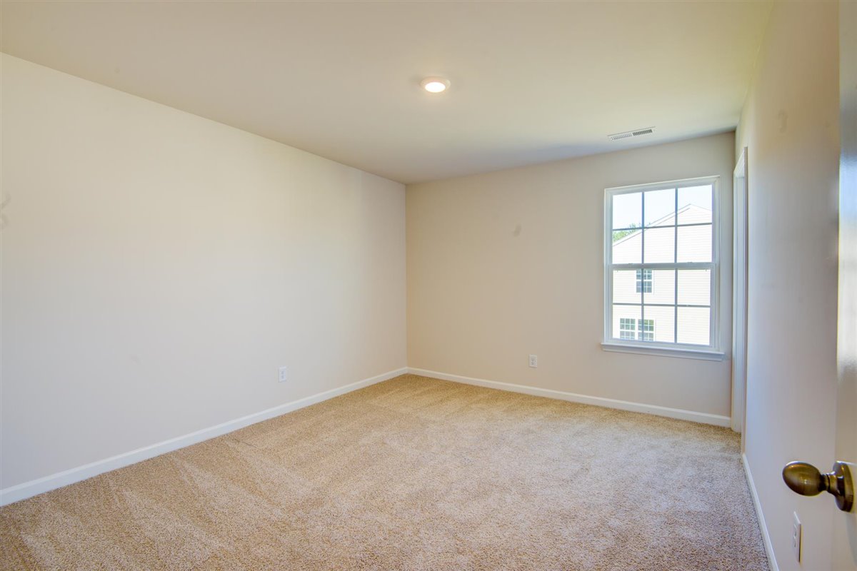 bedroom with carpet and natural light