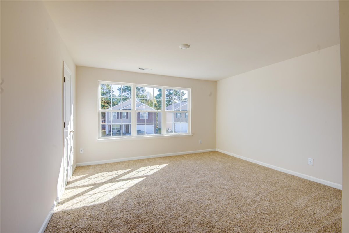 bedroom with carpet and natural light