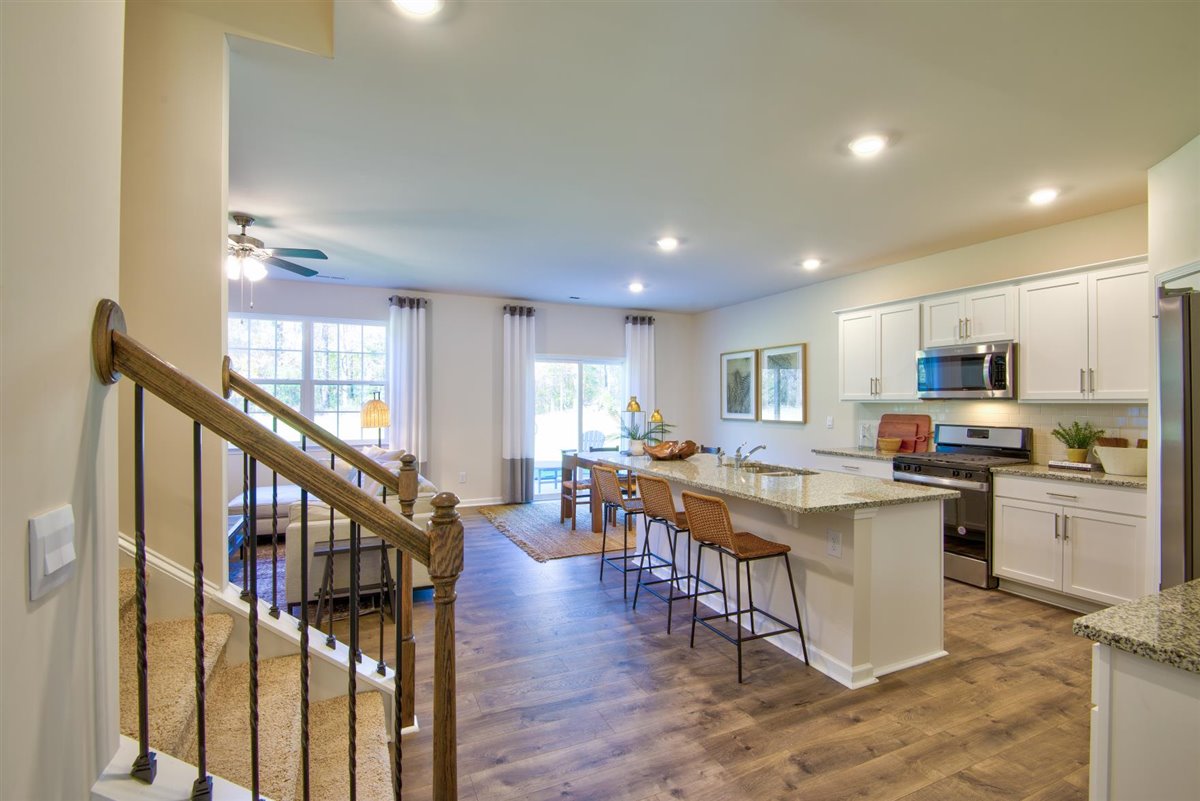 kitchen with vinyl floor, an island, and stainless steel appliances