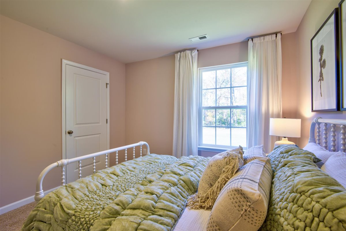 bedroom with carpet and natural light