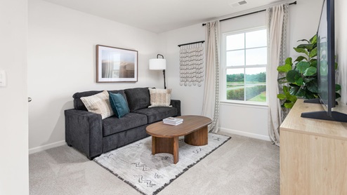 upstairs foyer with carpet and ample light