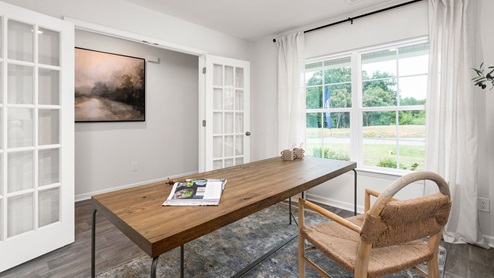Study with french doors and vinyl flooring