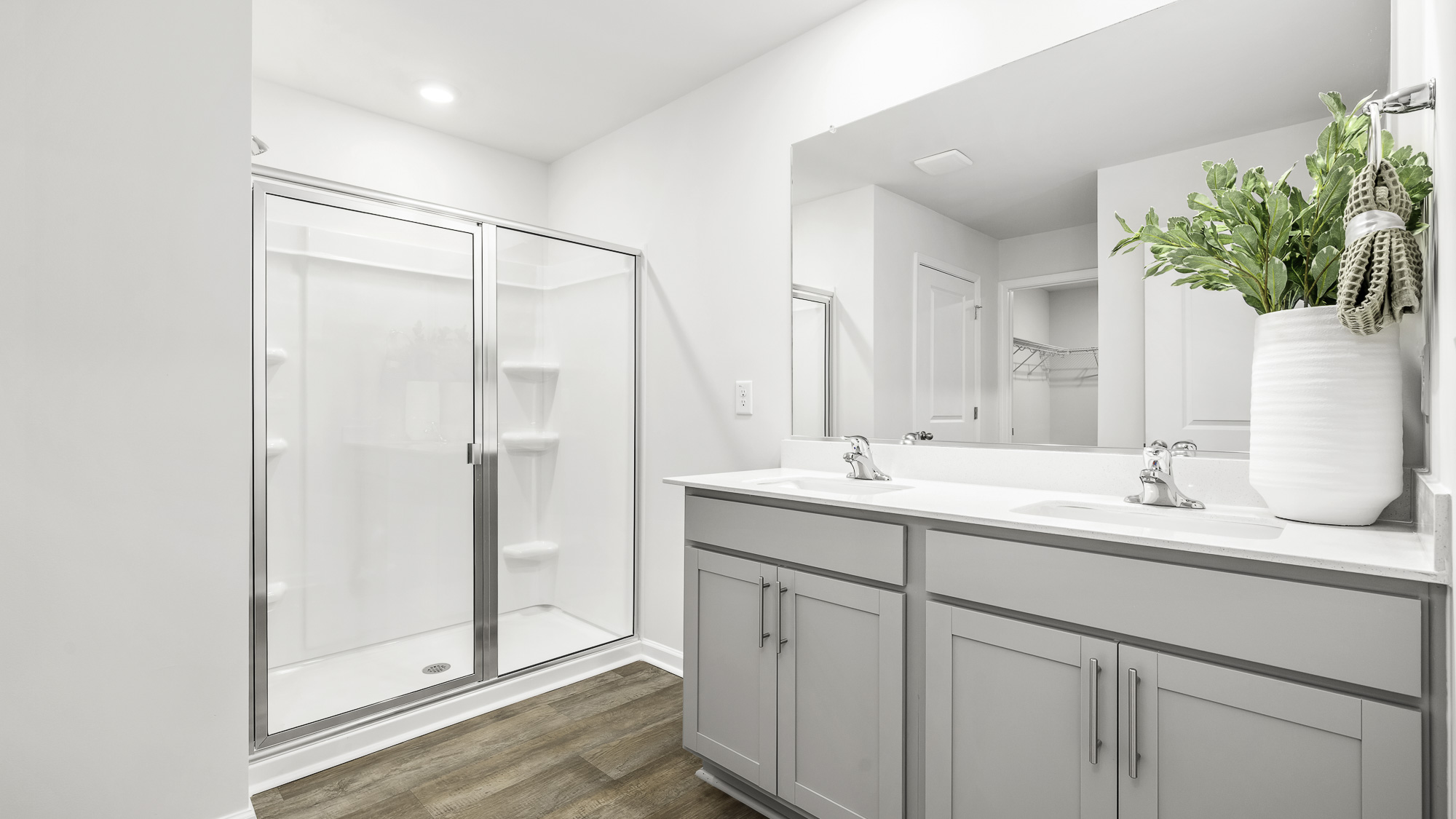 main bathroom with dual sink and walk-in shower