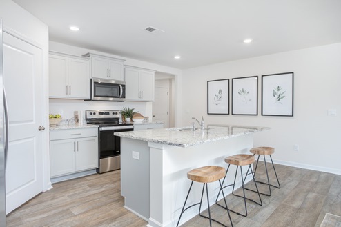 kitchen with vinyl floors an island and stainless steel appliances